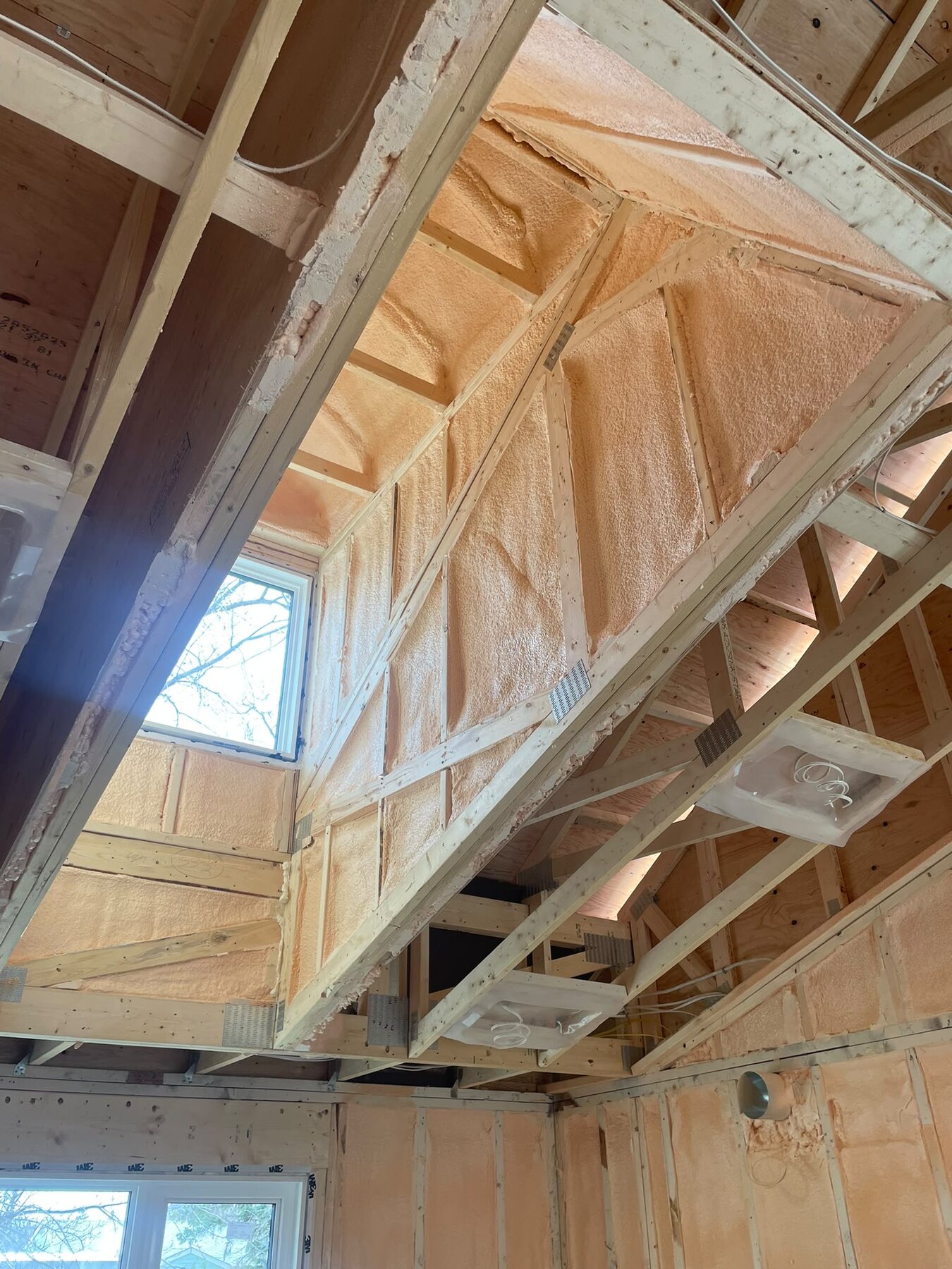 Complex dormer roofline with hip and valley framing foamed in closed-cell spray foam