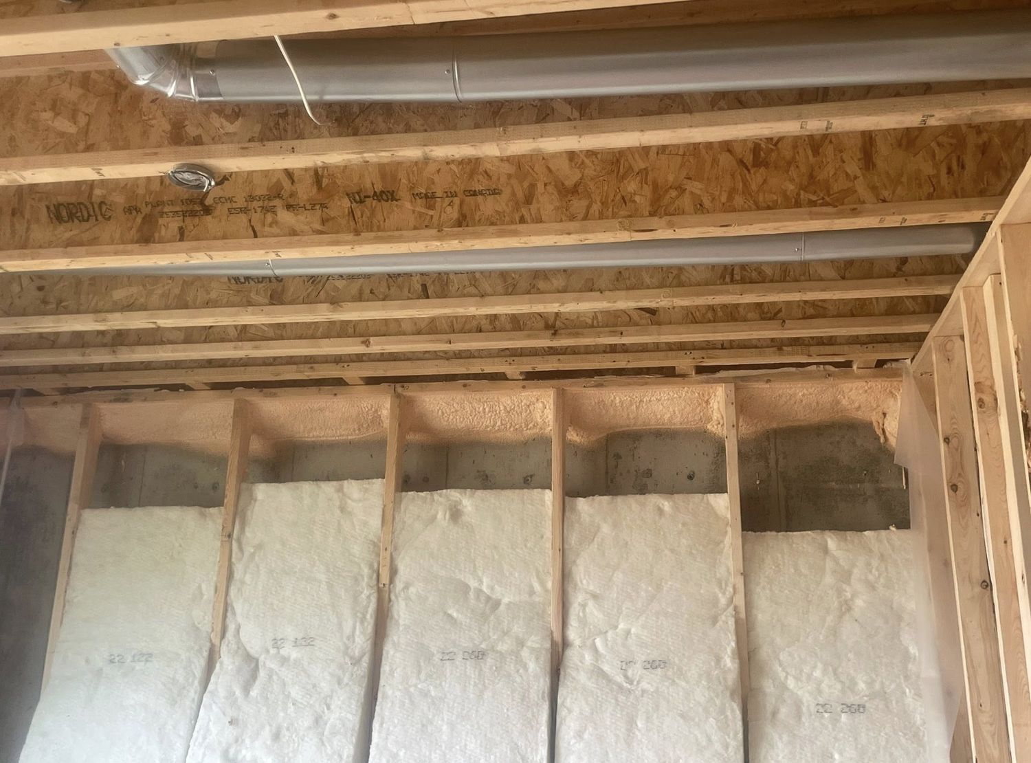 Rim joist spray foamed alongside batt insulation in a new construction home
