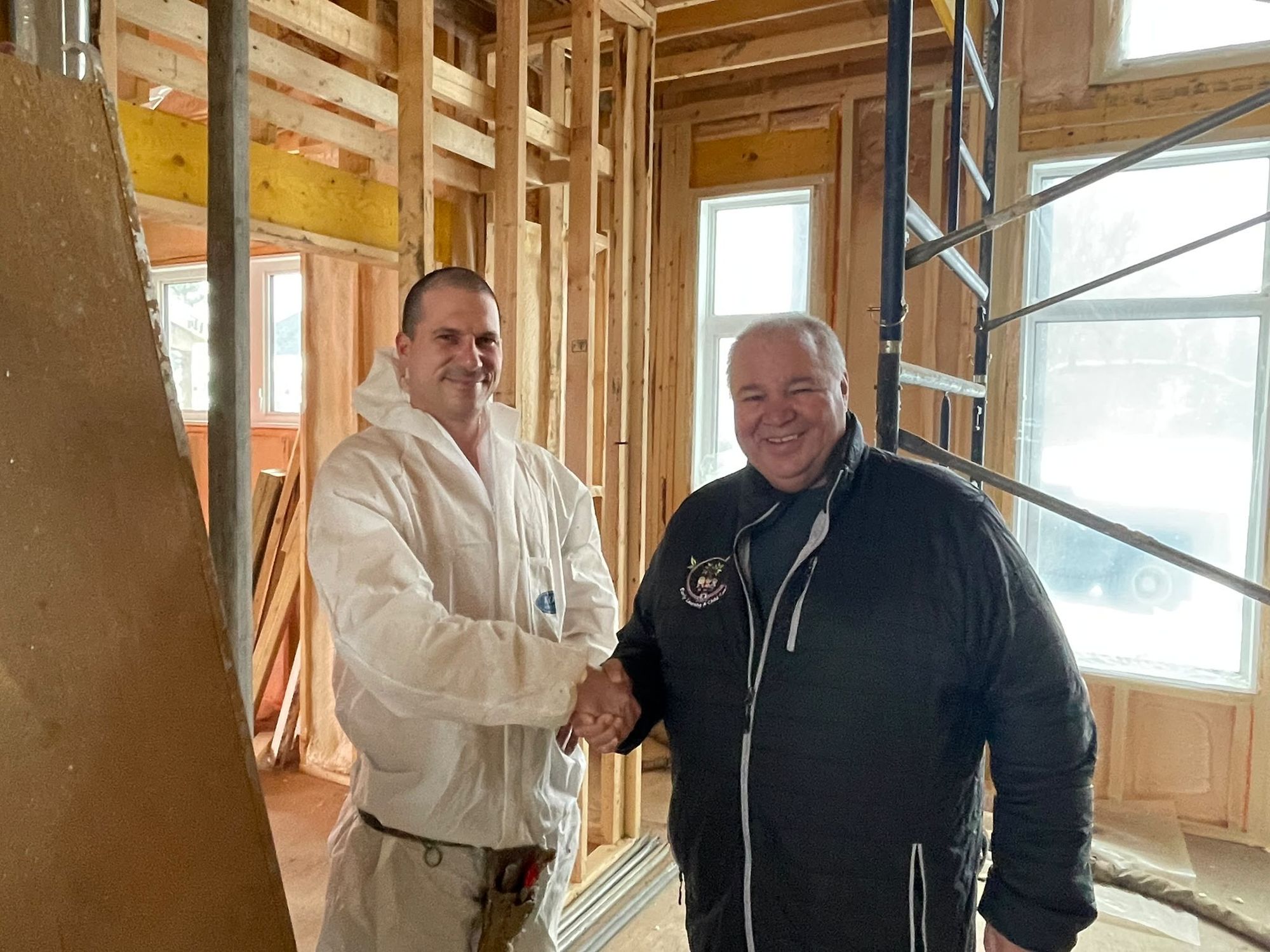 Stephane Ouellette shaking hands on a job site with David Chartrand, longtime president of the Manitoba Metis Federation